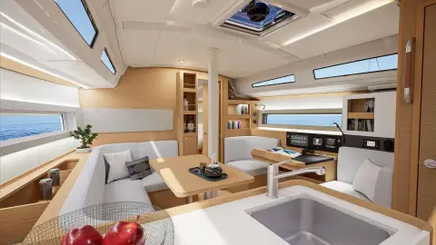 Jeanneau Sun Odyssey 385: saloon with light wood finish, L-shaped settee, galley sink in foreground and overhead hatch