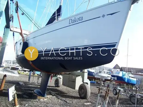 Jeanneau Sun Odyssey 40: hull ashore on hardstanding, dark blue topsides band, fin keel and spade rudder visible