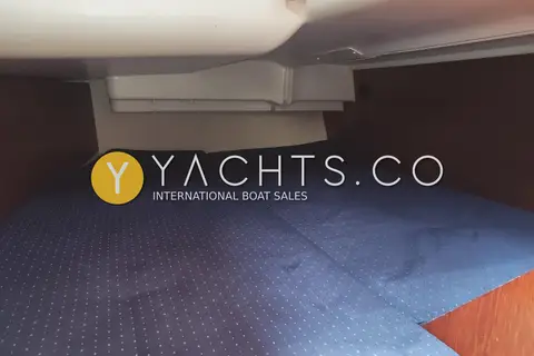 Jeanneau Sun Odyssey 40.3: low berth beneath the cockpit moulding with blue patterned cushions and wood side panels
