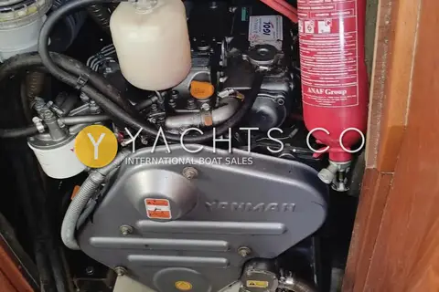 Jeanneau Sun Odyssey 40.3: engine bay showing the Yanmar diesel, coolant tank, fuel filter and red fire extinguisher