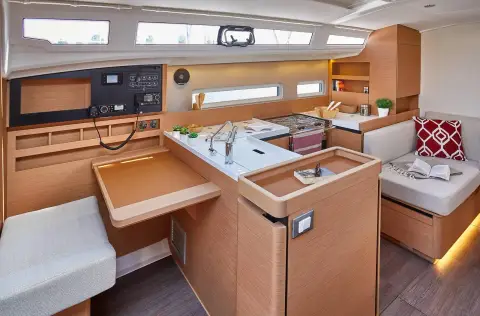 Jeanneau Sun Odyssey 410: chart table with instrument panel beside the galley, light wood finish and long hull windows