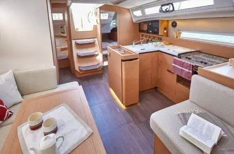 Jeanneau Sun Odyssey 410: saloon looking aft to companionway steps and galley, light wood joinery and grey floor