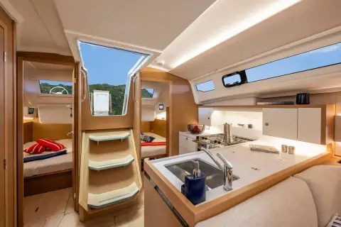 Jeanneau Sun Odyssey 415: companionway steps between aft cabins, with galley worktop and sink alongside
