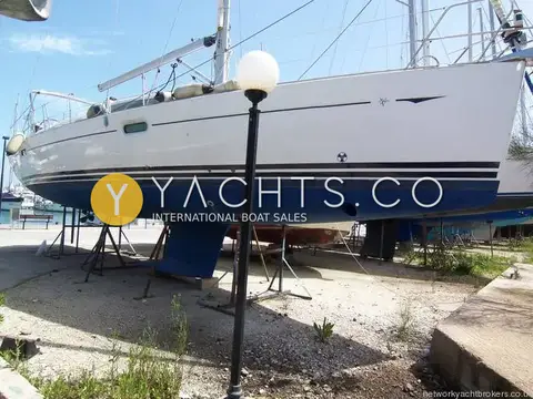 Jeanneau Sun Odyssey 42DS: hull ashore on stands in the boatyard, white topsides with blue stripes and antifouling
