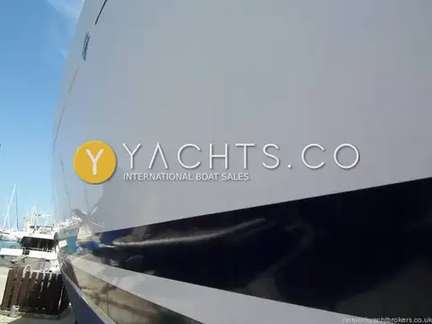 Jeanneau Sun Odyssey 42DS: close view of glossy white topsides and dark stripe, boat ashore in the marina