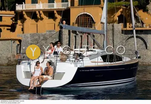 Jeanneau Sun Odyssey 44 DS: stern view at anchor with open bathing platform, twin wheels and people relaxing aboard