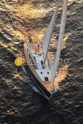 Jeanneau Sun Odyssey 44 DS: aerial view under full sail at sunset, showing deck saloon coachroof and wake