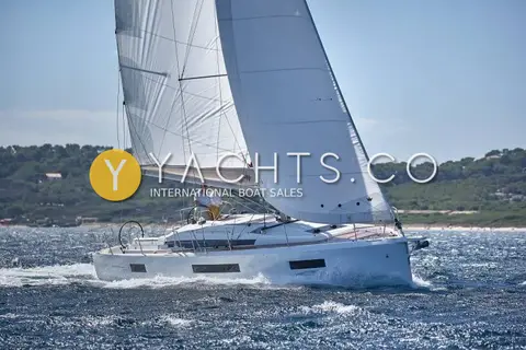 Jeanneau Sun Odyssey 440: beam view sailing upwind under main and genoa, hull ports along the topsides