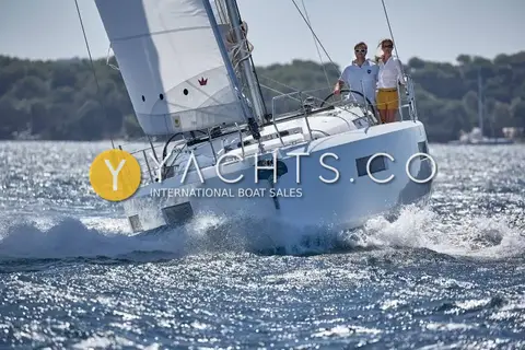 Jeanneau Sun Odyssey 440: bow-on view under sail showing the bowsprit with anchor roller and walk-around side decks