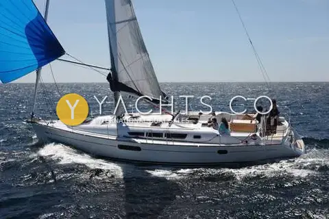 Jeanneau Sun Odyssey 44I: sailing with blue gennaker set, crew relaxing in the cockpit
