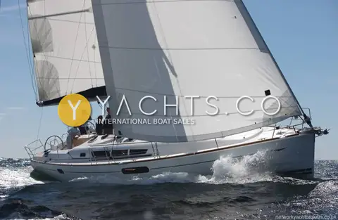 Jeanneau Sun Odyssey 44I: close-hauled under main and genoa with crew gathered at the twin helms