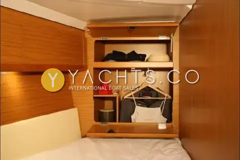 Jeanneau Sun Odyssey 50 DS- 360 Docking With: cabin hanging locker and open shelving in light wood at the foot of a berth