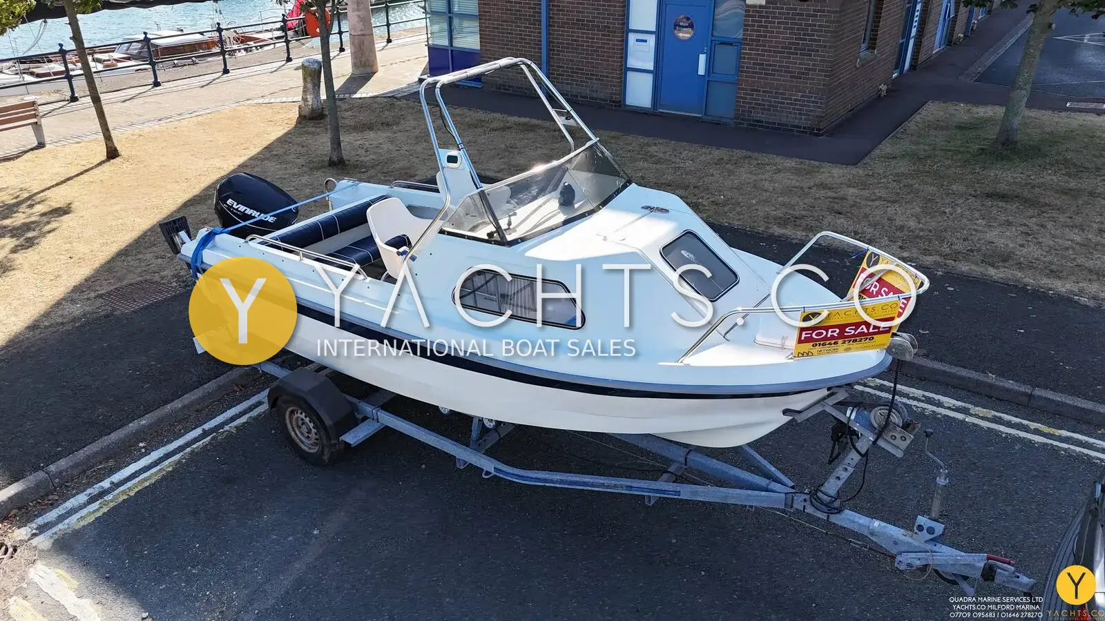 Kingfisher 166 Sports Fisher: white hull with cuddy cabin and windscreen on a road trailer, viewed from the bow quarter