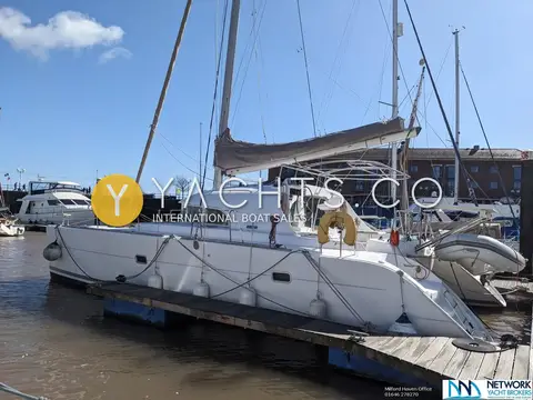 Lagoon 380: port side view of the catamaran alongside a pontoon, RIB on stern davits