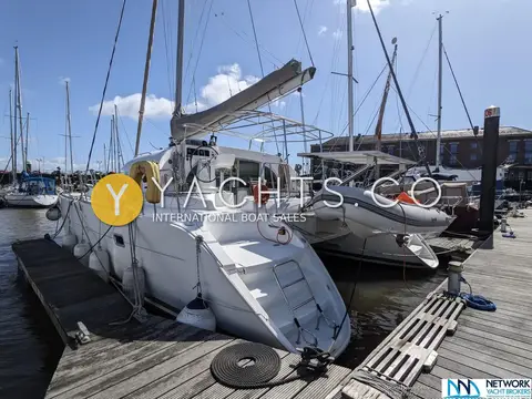 Lagoon 380: stern quarter with bathing steps, horseshoe buoy and RIB hanging on davits