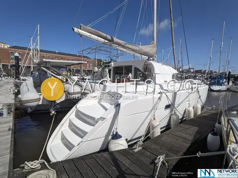 Lagoon 380: starboard stern steps showing boat name TopCat, fenders out along the pontoon