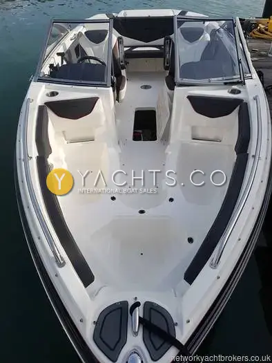 Larson 2300 LSR: bow area from above with seat cushions removed, showing moulded seating and open windscreen