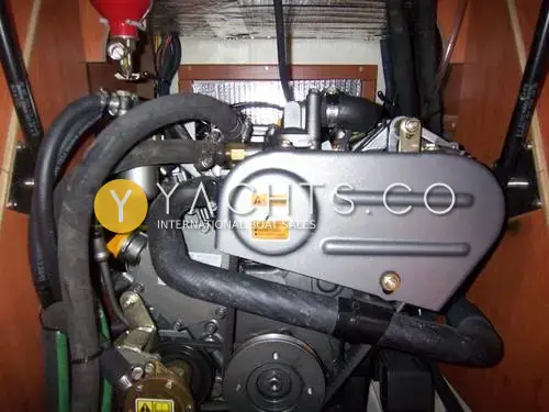 Legend 27: engine bay with the Yanmar diesel, black hoses and fire extinguisher mounted above