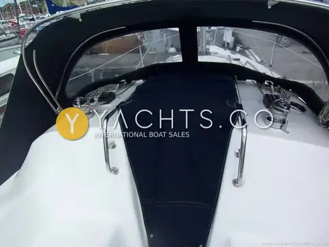 Legend 27: navy spray hood over the companionway with winches and grab rails on the coachroof