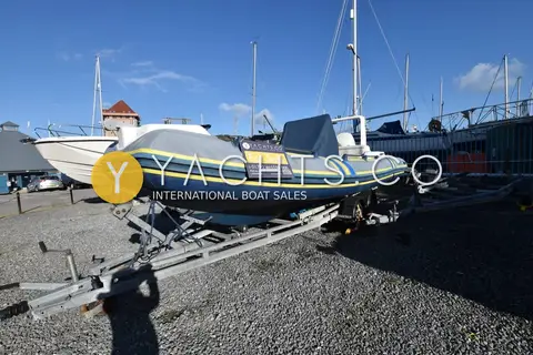Marlin 640 FB Rib: bow quarter view of the RIB on her trailer in a boatyard under blue sky