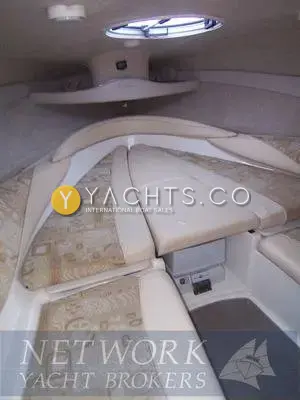 Maxum 2100 SC: forward cabin V berth with patterned cushions, centre filler and overhead hatch