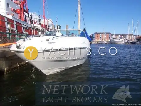 Maxum 2100 SC: bow view afloat in a marina, red lightship moored behind