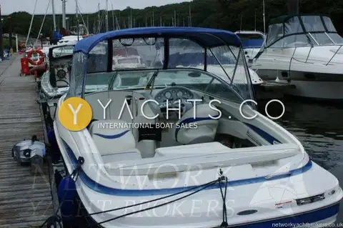 Maxum 2100 SC: stern view into cockpit with canopy up, moored on a wooded marina pontoon