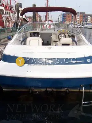 Maxum 2300 SC: stern view over bathing platform into cockpit with bimini, moored in Swansea marina
