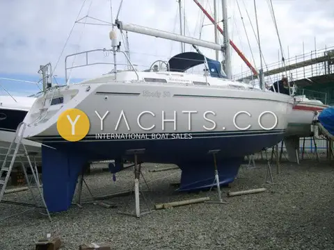 Moody 38CC Yacht For Sale: hull ashore on stands with blue antifouling, shoal fin keel and spade rudder visible