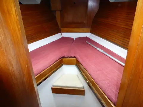 Moody 42 CC Ketch: forward cabin with V berths in burgundy upholstery and varnished timber lining