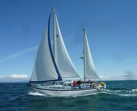 Moody 42 CC Ketch: under full sail at sea with genoa, main and mizzen set on a sunny day