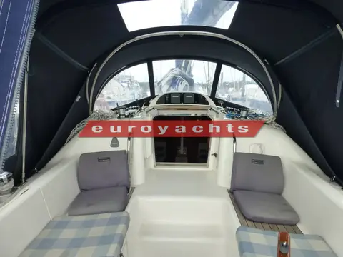 Moody S31: cockpit enclosed by the full dark canopy, looking forward to the companionway and sprayhood