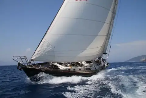 Mystic 60: sailing hard on the wind with genoa set, bow throwing spray
