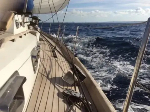 Mystic 60: teak side deck heeled under sail, winch and deck fittings along the coachroof