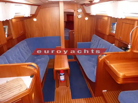 Najad 380: saloon looking forward, settees either side and central table with drop leaves folded