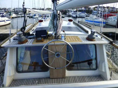 Nauticat 33: outside aft helm with stainless wheel, plotter and winches on teak deck