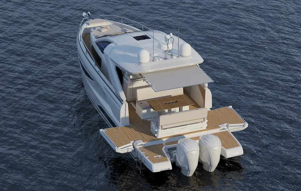 Jeanneau DB 37 OB: aerial stern view showing teak cockpit, fold-out side terraces, bathing platform and twin outboard engines