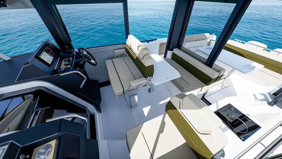 Jeanneau EX 34 Cabin: wheelhouse from above, with helm, chart display, facing bench seats around a table and sink unit
