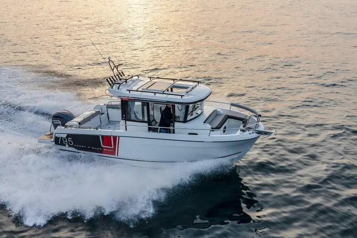Jeanneau Merry Fisher 795 Sport: aerial view underway on calm evening water, showing wheelhouse, roof rack, rod holders and bow seating