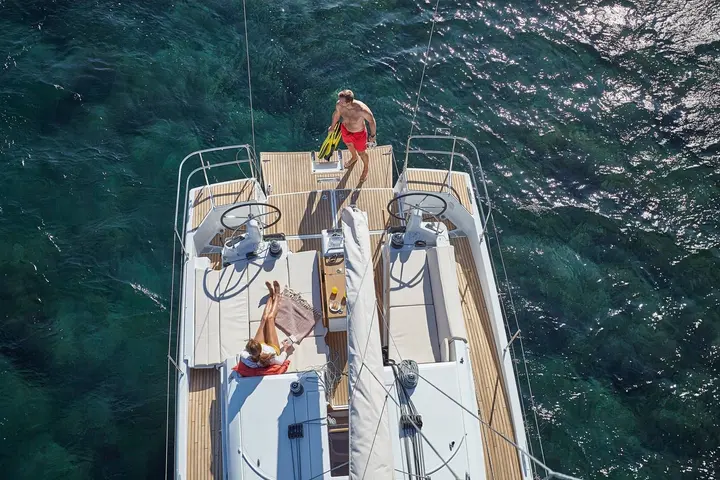 Jeanneau Sun Odyssey 440: overhead view of the teak cockpit with twin wheels, central table and cushioned benches
