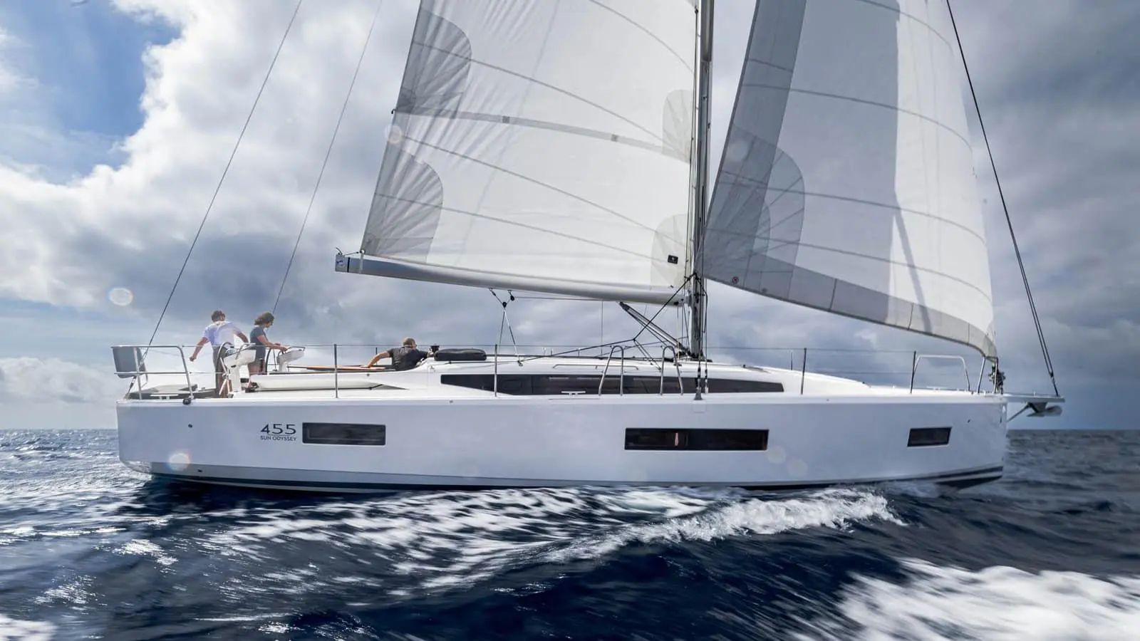 Jeanneau Sun Odyssey 455: under sail in choppy water, full mainsail and headsail set, crew in the cockpit