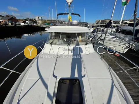 Nimbus 380 Commander: foredeck looking aft to the wheelhouse windscreen and flybridge, deck hatch in foreground