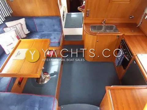 Nimbus 380 Commander: saloon from above with blue upholstered seating, teak table and galley with twin sink