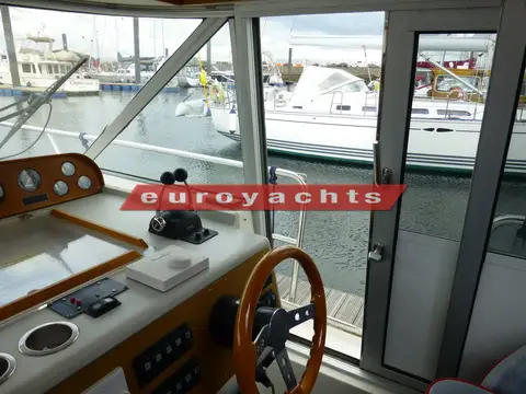 Nimbus 380 Commander: lower helm with compass and sliding side door open to the deck