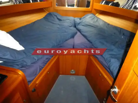 Nimbus 380 Commander: forward cabin V berths with blue covers and storage drawers beneath