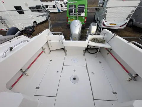 Orkney Boats Pilot House 20 Mk II: self-draining white cockpit with floor hatches, outboards visible on boatyard trailer