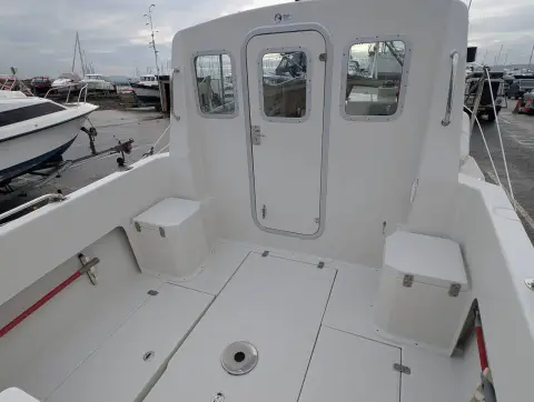 Orkney Boats Pilot House 20 Mk II: cockpit looking forward to wheelhouse door, with seat lockers on each side