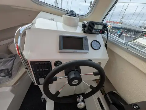 Orkney Boats Pilot House 20 Mk II: helm station with wheel, chartplotter, compass and VHF radio mounted above