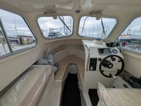 Orkney Boats Pilot House 20 Mk II: wheelhouse interior looking forward, helm to starboard, berth cushions still wrapped in plastic