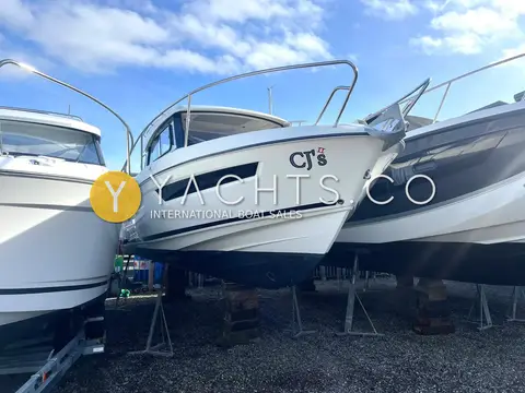Parker 750 CC: bow quarter view ashore on stands between other boats under a bright sky